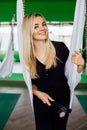 Portrait of a cute beautiful girl mekeup artist natural with long hair blond. In the studio, anti gravity fitness yoga . Royalty Free Stock Photo