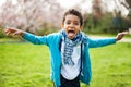 Portrait of a cute black boy making faces and showing his tongue in the park Royalty Free Stock Photo