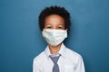 Portrait of cute black child boy in medical protective face mask