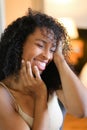 Portrait of cute black girl sitting in room and wearing beige lingerie. Royalty Free Stock Photo