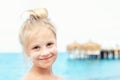 Portrait of cute blond kid girl applying sunscreen protection creme on  face. Mom using sunblocking lotion to protect baby Royalty Free Stock Photo