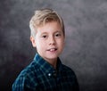 Portrait of a cute blond teenage boy dressed in a plaid shirt Royalty Free Stock Photo