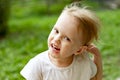 Portrait of cute blond toddler girl in a windy summer day making faces Royalty Free Stock Photo