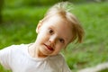 Portrait of cute blond toddler girl in a windy summer day making faces Royalty Free Stock Photo