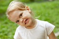 Portrait of cute blond toddler girl in a windy summer day making faces Royalty Free Stock Photo