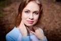 Portrait of cute blonde girl in blue dress outdoors. Nice woman posing on nature landscape Royalty Free Stock Photo