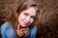 Portrait of cute blonde girl in blue dress outdoors. Nice woman posing on nature landscape Royalty Free Stock Photo