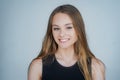 Portrait of a cute blonde girl standing on white background. Close up portrait of young cheerful beautiful girl with Royalty Free Stock Photo