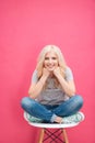Portrait of a cute blonde woman sitting on the chair Royalty Free Stock Photo