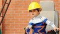 Portrait of a cute boy as excavator operator