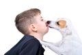 Portrait of a cute boy being licked by a dog