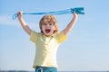 Portrait of cute boy exercising with jumping rope on blue sky background. Kid skipping rope during sunny morning. Royalty Free Stock Photo