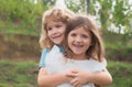 Portrait of cute boy and girl on summer field. Children in summer park. Cute kids face close-up. Playful little brother Royalty Free Stock Photo