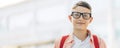 Portrait of a cute boy in glasses who is going to school with his school backpack, Student boy on the way to school Royalty Free Stock Photo