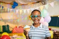 Portrait of cute boy holding cupcake during birthday party