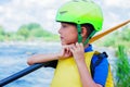 Portrait of cute boy kayaking on the river on a sunny day during summer vacation Royalty Free Stock Photo