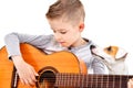 Portrait of a cute boy playing acoustic guitar with his dog Jack Russell Terrier Royalty Free Stock Photo