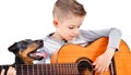 Portrait of a cute boy playing acoustic guitar with his dog Jagdterrier Royalty Free Stock Photo