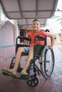 Portrait of cute boy sitting on wheelchair in corridor Royalty Free Stock Photo