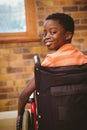 Portrait of cute boy sitting in wheelchair