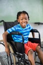 Portrait of cute boy sitting on wheelchair Royalty Free Stock Photo