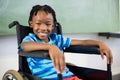 Portrait of cute boy sitting on wheelchair Royalty Free Stock Photo