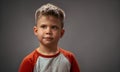 Portrait of a cute boy in the studio. Brooding look up. High quality photo