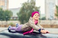 Portrait of cute caucasian blond little girl having fun playing at modern outdoor playground at city park in autumn