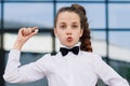 Portrait of cute caucasian teen girl holding coin. Saving money concept