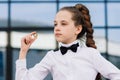 Portrait of cute caucasian teen girl holding coin. Saving money concept