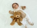 Portrait of a cute charming smiling four-month-old baby boy lying on a bed Royalty Free Stock Photo