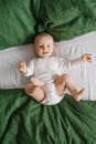 Portrait of a cute charming smiling laughing Caucasian white boy of six months old lying on a bed and looking at the camera. View Royalty Free Stock Photo