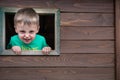 Cheeky boy looking through the window Royalty Free Stock Photo