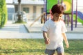 Portrait of cute cheerful baby Asian boy working or running on green grass in at playground Royalty Free Stock Photo