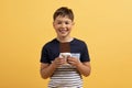 Portrait of cute cheerful preteen kid holding chocolate bar Royalty Free Stock Photo