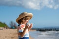 Portrait of a cute child boy in straw hat. Close up caucasian kids face. Closeup head of funny kid on summer beach. Royalty Free Stock Photo