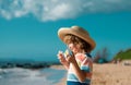 Portrait of a cute child boy in straw hat. Close up caucasian kids face. Closeup head of funny kid on summer beach. Royalty Free Stock Photo