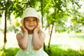 Portrait of cute child girl model in hat smiling in park or outdoor. Happy childhood, summer holidays and vacations Royalty Free Stock Photo