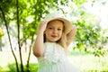 Portrait of cute child girl model in hat smiling in park or outdoor. Happy childhood, summer holidays and vacations Royalty Free Stock Photo