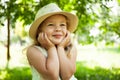 Portrait of cute child girl model in hat smiling in park or outdoor. Happy childhood, summer holidays and vacations Royalty Free Stock Photo