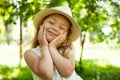 Portrait of cute child girl model in hat smiling in park or outdoor. Happy childhood, summer holidays and vacations Royalty Free Stock Photo