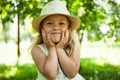 Portrait of cute child girl model in hat smiling in park or outdoor. Happy childhood, summer holidays and vacations Royalty Free Stock Photo