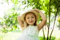 Portrait of cute child girl model in hat smiling in park or outdoor. Happy childhood, summer holidays and vacations Royalty Free Stock Photo