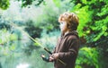 Portrait of cute child little boy fishing. Kid with spinning reel. Royalty Free Stock Photo