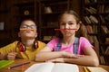 Portrait of cute children holding pencil on mouth under nose