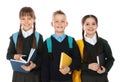 Portrait of cute children in school uniform with backpacks and books Royalty Free Stock Photo