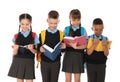 Portrait of cute children in school uniform with books on white Royalty Free Stock Photo