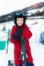 Portrait of cute confident adorable little kid boy enjoy having fun walking with ski at alpine mountain skiing resort on Royalty Free Stock Photo