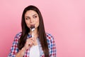 Portrait of cute cunning pretty girl eating tasty food lick spoon cheating her diet isolated on pink color background Royalty Free Stock Photo