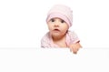 Portrait of cute curious baby girl, peeking from behind a banner Royalty Free Stock Photo